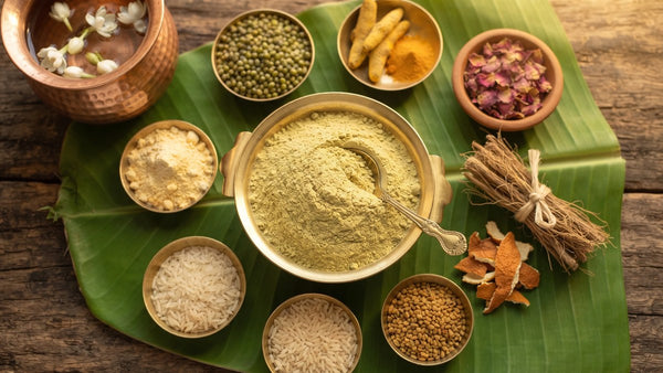 Sunni pindi Telugu herbal bath powder in a brass bowl with green gram, turmeric, rose petals and herbs