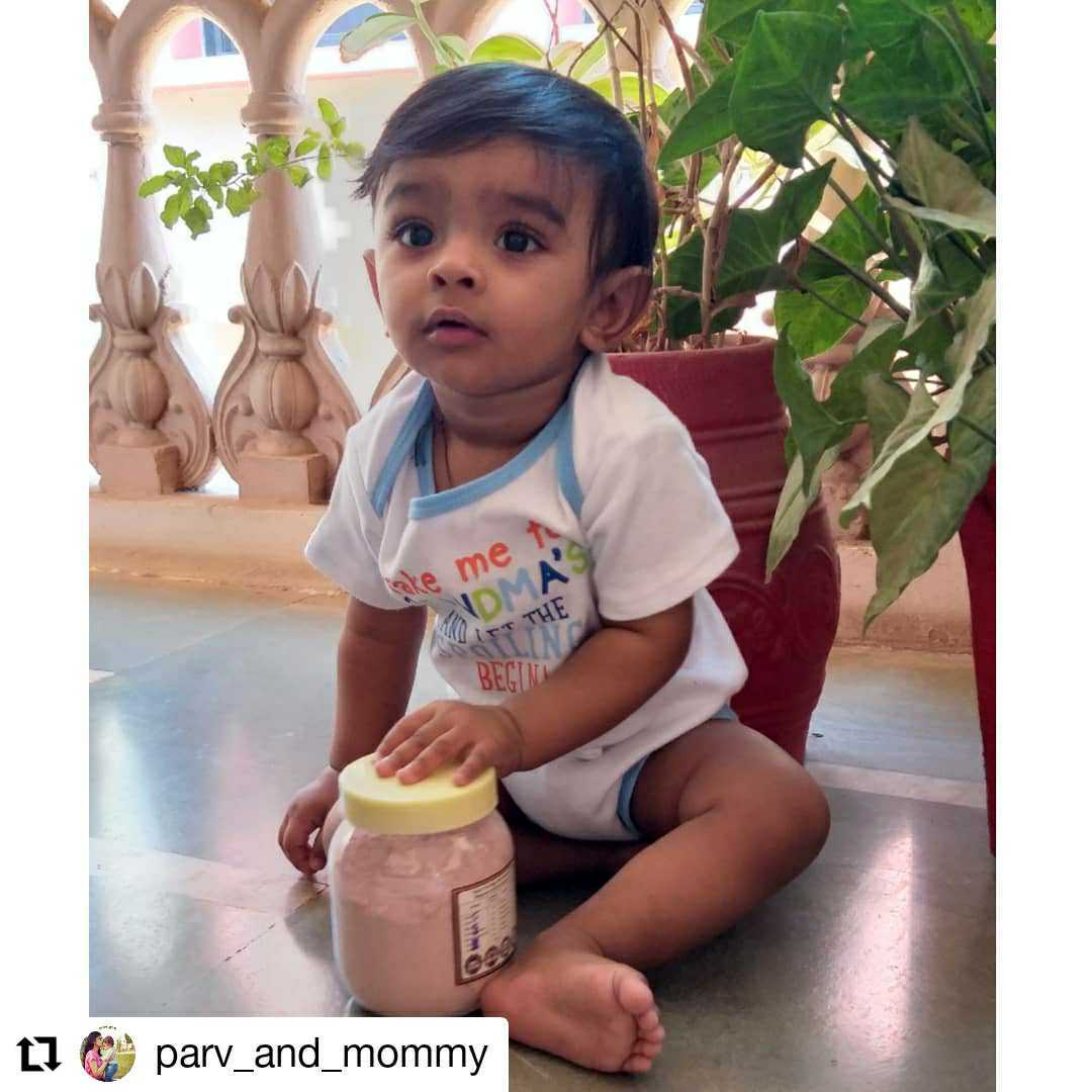 Baby playing with ByGrandma porridge jar